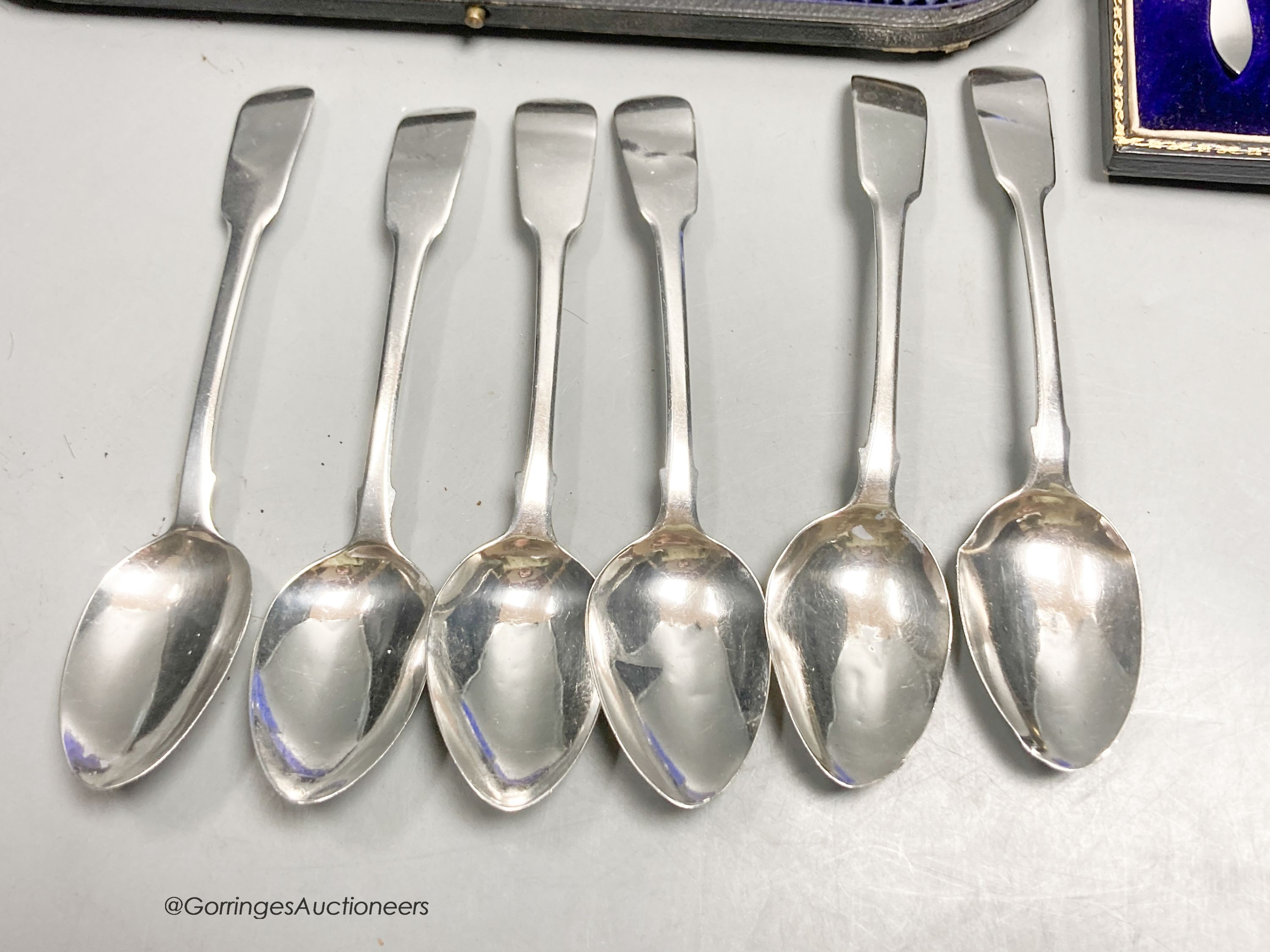 A set of six George IV silver fiddle pattern teaspoons, London, 1823, a later cased set of six silver coffee spoons and a cased mother of pearl handled silver toasting fork.